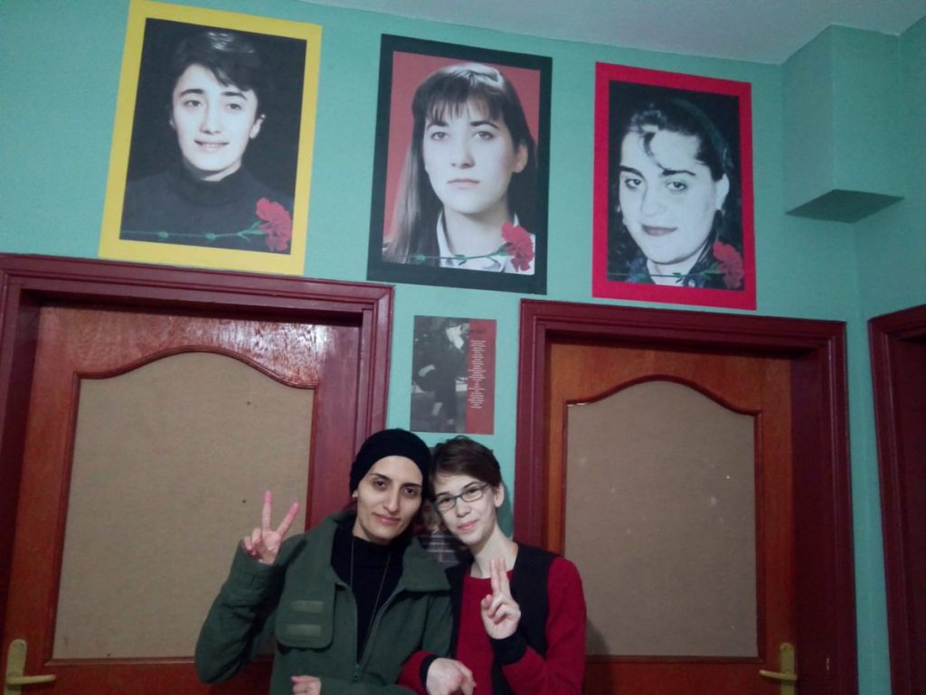 Helin(left) and Bahar(right) below the portraits of Ayse Gunel, Ayce Idil Erkmen and Ayse Gulen(from left to right)